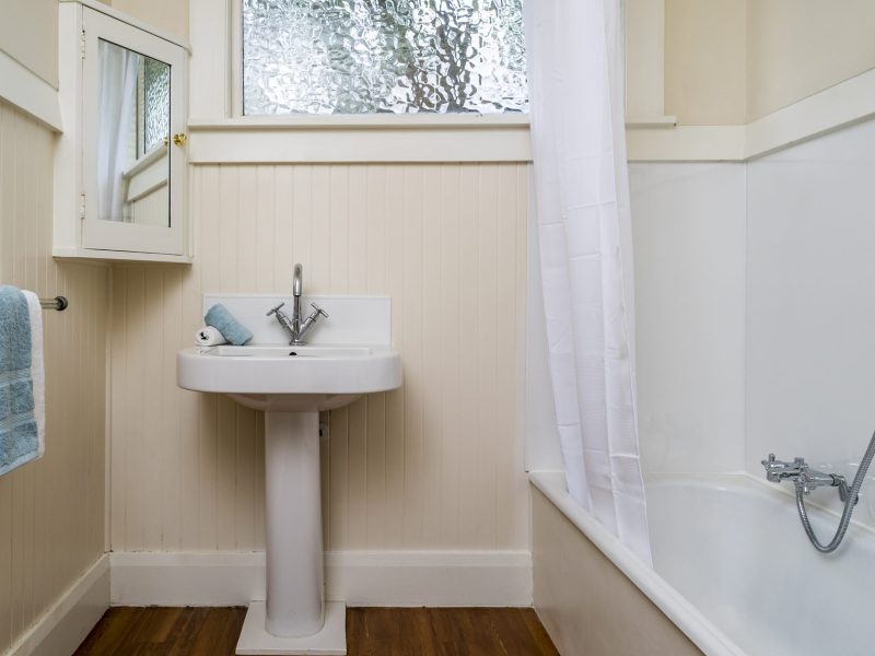 The small bathroom with a window in the apartment